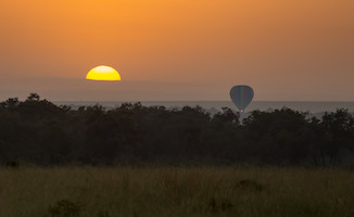 Hot air ballon taking off for a sunrise journey over the Maasai Mara